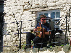 Matt Butcher, our 'sometimes' melodean player, on 'the ledge' at Clovelly Maritime festival